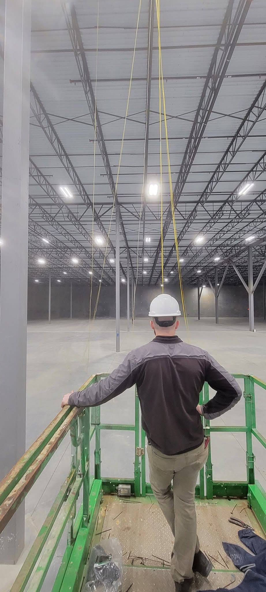 Fiber cable pull during structured cabling rough-in at a warehouse facility