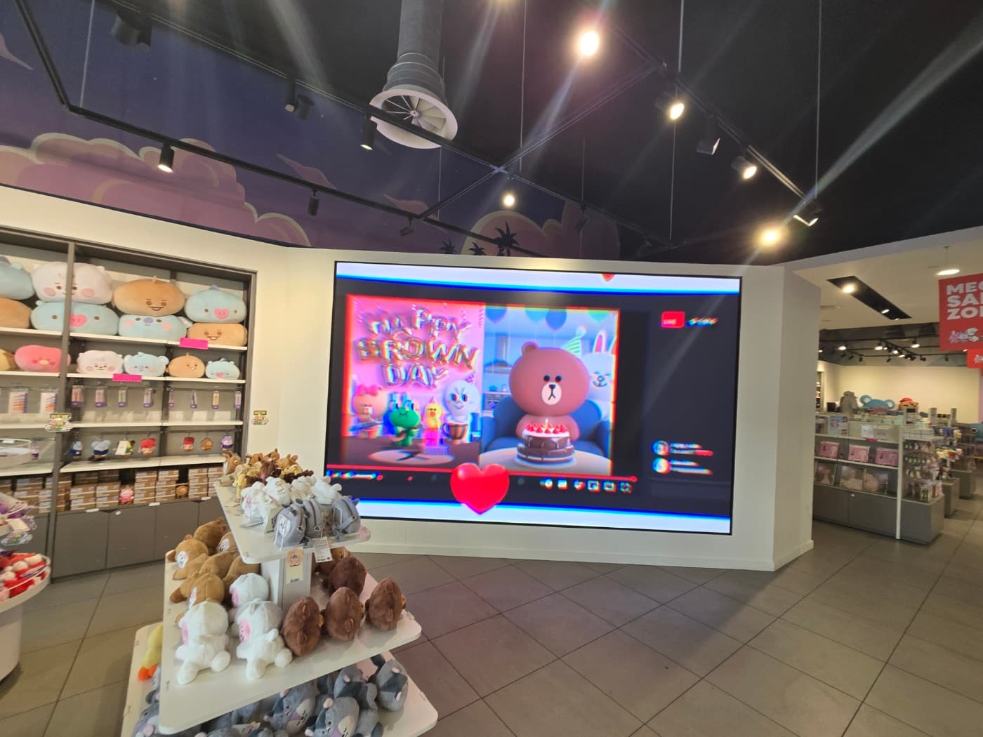In-store LED display integrated into a retail merchandising area