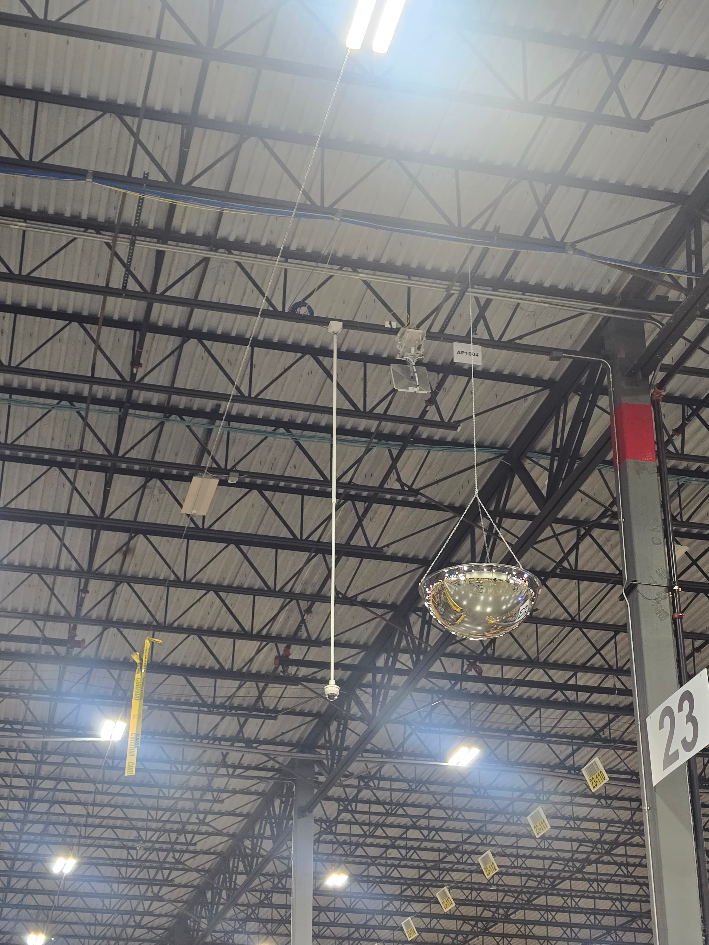 Wireless access point and security camera installed in a warehouse ceiling structure